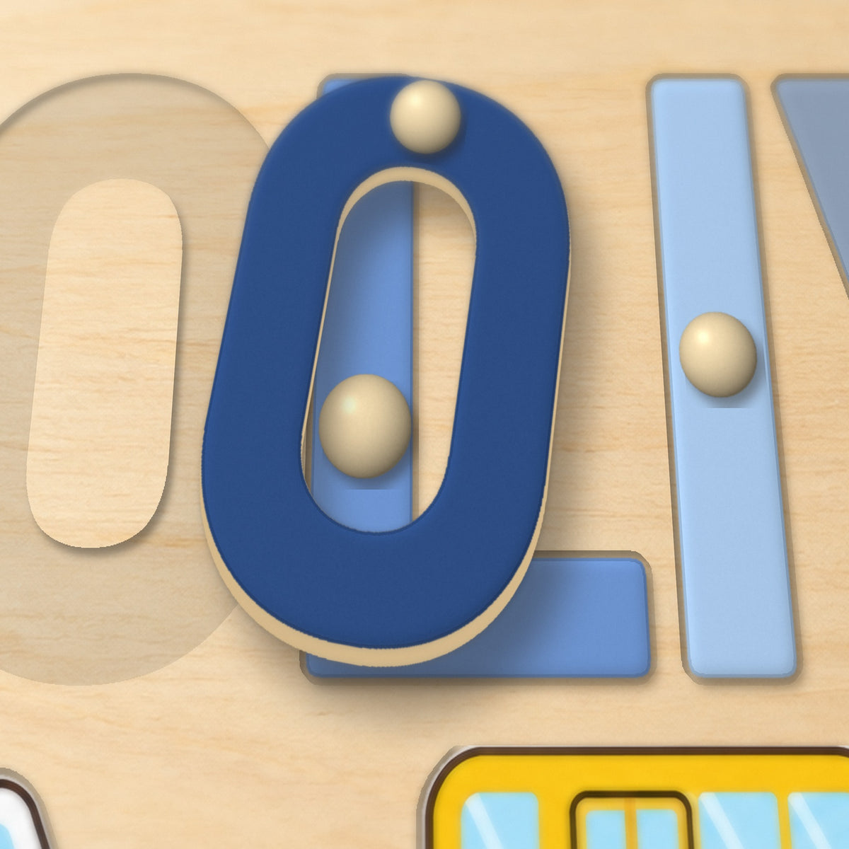 Close-up of a wooden letter lifted out by its knob